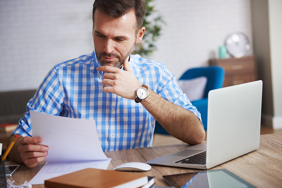 Homme qui lit une feuille dans un bureau